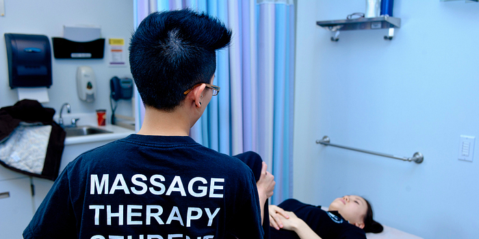 picture of a centennial college massage therapy student at the benefit clinic fundraiser to fight aids in africa